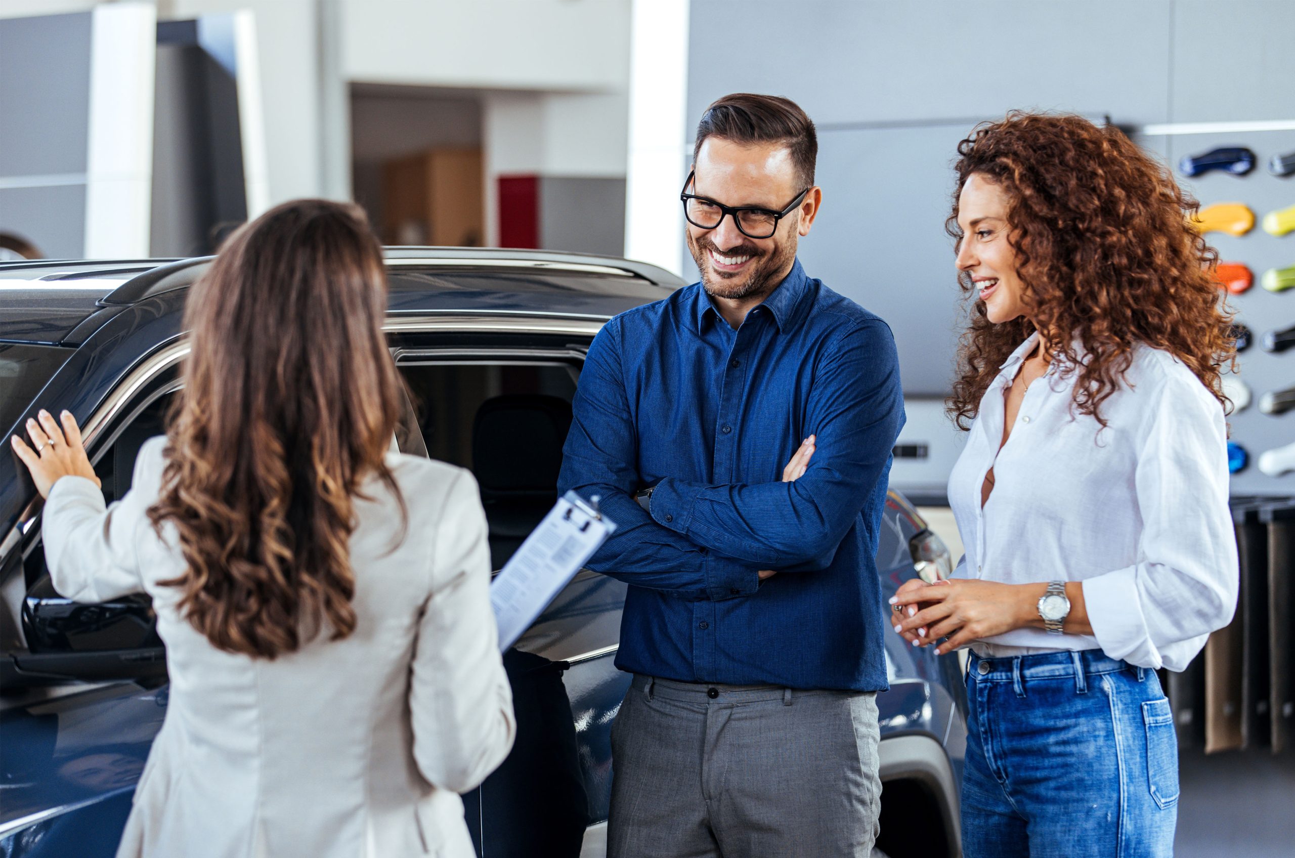 A,Car,Salesman,Is,Showing,New,Cars,To,A,Couple.